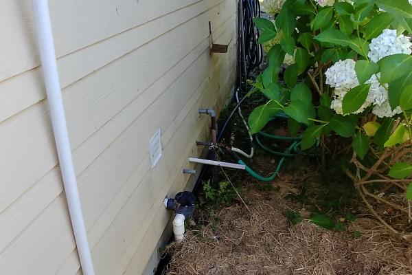 Outdoor connection between washing machine source and watering system